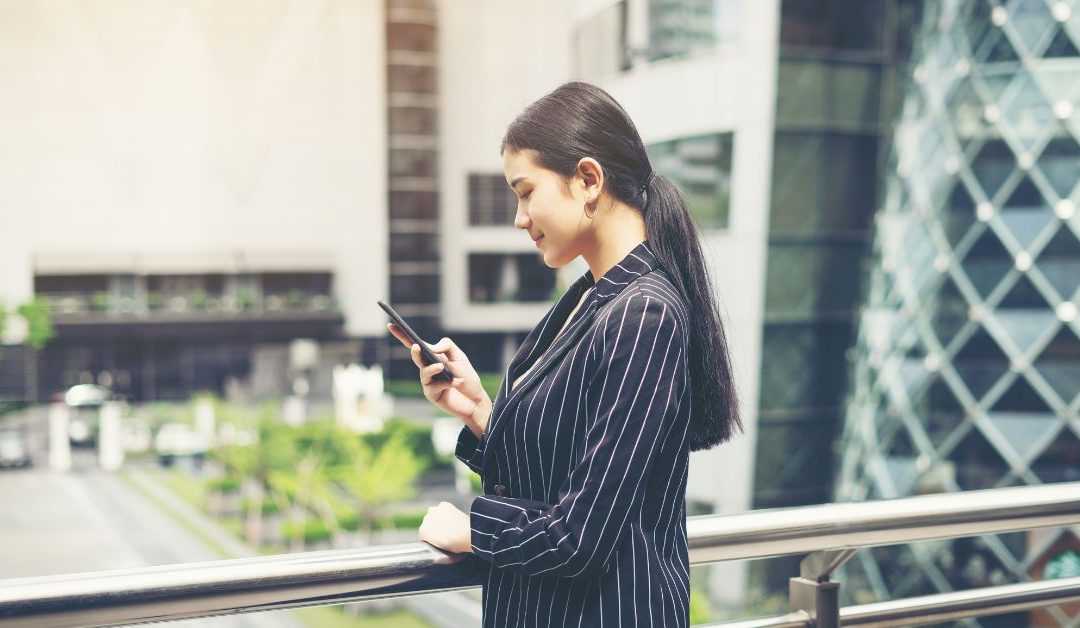 Singapore CBD with a business professional planning on a mobile device, symbolising starting a company in the new year